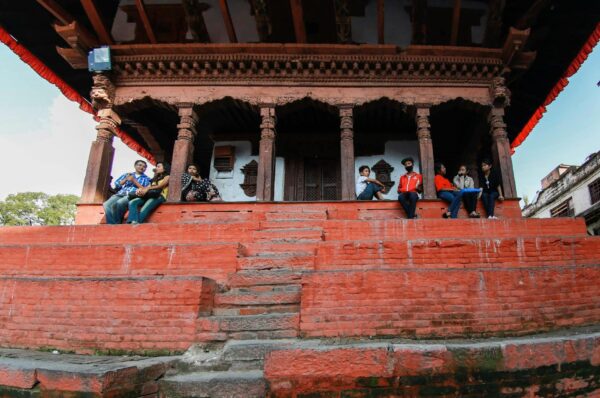 low angle shot of people sitting on concrete staircase